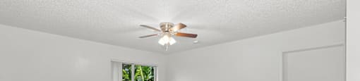 Living room with ceiling fan at Running Brook Apartments in Miami FL
