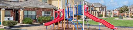 Outdoor playground at Ironwood Crossing Apartments and Townhomes in Fort Worth TX