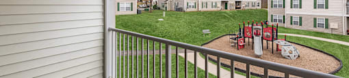Apartments for Rent in Fredericksburg - England Run North - Playground with Climb Equipment and Slide Surrounded by Grass