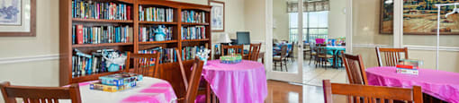 Seating and bookshelf in lounge at Parkway Senior Apartments in Pasadena TX