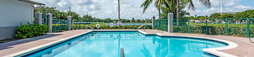Swimming Pool and Lake View at Cedar Grove Apartments in Miami Gardens FL