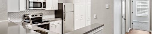 Kitchen counter and view of hallway at England Run Apartments in Fredericksburg VA