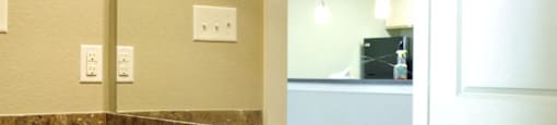 A bathroom with a sink and mirror at Centre Place Apartments, Denton
