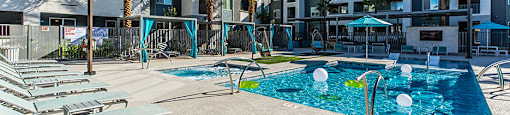 Pool with lounge chairs at ARISTA APARTMENT HOMES, Las Vegas
