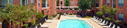 Luxury apartments with large swimming pool, multiple swimming pools, spa, and large sundeck with poolside lounge chairs at The Lanesborough Apartments in Houston