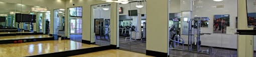 Luxury apartments with huge fitness center with multiple varieties of workout equipment, free weights, yoga and spin rooms at The Lanesborough Apartments in Houston