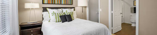 Spacious master bedroom with attached master bathroom and walk-in closet, ceiling fan and 9-foot ceilings at The Lanesborough Apartments in Houston.