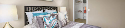 Spacious bedroom with walk-in closet and ceiling fan at The Lanesborough Apartments in Houston.