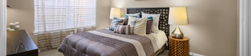 Spacious bedroom with walk-in closet and ceiling fan at The Lanesborough Apartments in Houston.