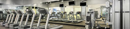 Luxury apartments with huge fitness center with multiple varieties of workout equipment, free weights, yoga and spin rooms at The Lanesborough Apartments in Houston.