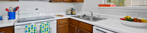 Luxury apartments with spacious kitchens, custom home cabinets, recessed ceiling and side-by-side refrigerators at The Lanesborough Apartments in Houston.