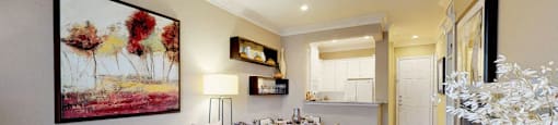 Spacious living room, spacious dining room, kitchen with granite countertops, white cabinets, and breakfast bar at Tuscany Court Apartments in Houston.