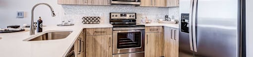 a kitchen with wooden cabinets and stainless steel appliances
