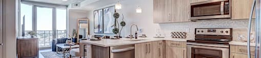 a kitchen with wooden cabinets and stainless steel appliances