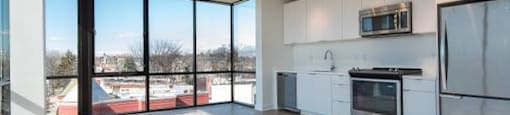 an empty room with a stove and a refrigerator