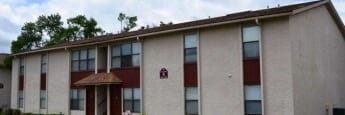 Building with a red door and windows.