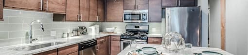 a kitchen with wooden cabinets and stainless steel appliances
