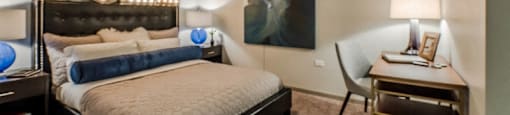 a bedroom with a bed and a desk