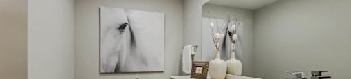 a bathroom with a toilet sink and a painting on the wall