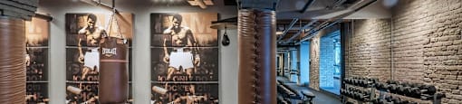 Chicago luxury apartment fitness center gym amenity with treadmills, bikes, boxing punching bags, free weights, and ellipticals