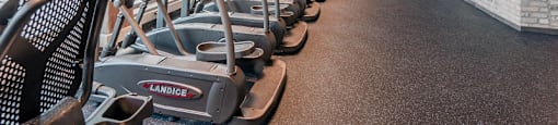 Chicago luxury apartment fitness center gym amenity with treadmills, bikes, and ellipticals