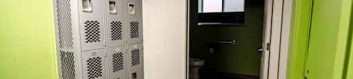 a room with some lockers and a toilet in it