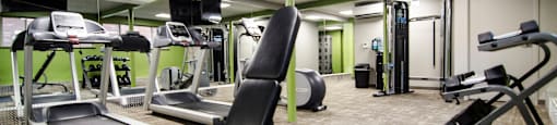 a gym with treadmills and other exercise equipment in a building