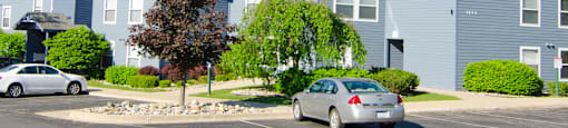 a blue apartment building with cars parked in front of it