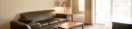 an empty living room with a couch and a table