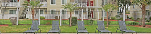 Row of lounge chairs by pool at PARKSIDE BRENTWOOD, Brentwood, CA
