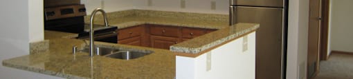 Gourmet Kitchens with Islands, Caesarstone Countertops, and Decorative Backsplash at Foresthill Highlands Apartments & Townhomes 55+, 8930 West Highland Park Avenue, Wisconsin
