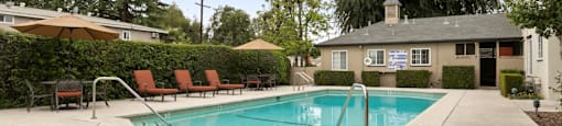 Apartments in Van Nuys, CA - Colonial Manor Swimming Pool with Lounge Chairs and Umbrella Covered Table Seating