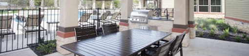 a patio with a table and chairs and a ceiling fan
