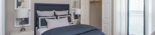 a bedroom with a bed and a ceiling fan