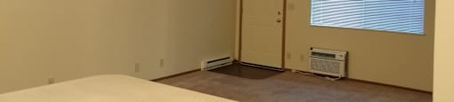 Image of carpeted living room and door