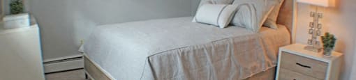 a bedroom with a bed and a window  at Valley York Apartments, Ohio