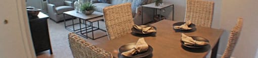 a dining room with a table and chairs and living room in the background  at Valley York Apartments, Ohio