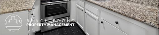 A kitchen with granite countertops and white cabinets.