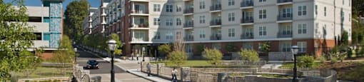 an apartment building on a city street with a bridge at Glenwood Park Lofts, Atlanta