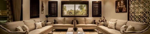 A well-lit, modern living room with a central coffee table and multiple seating options.