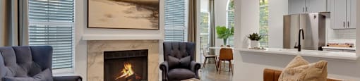 A living room with a fireplace and a painting on the wall.