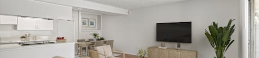 A living room with a couch, chair, and television.