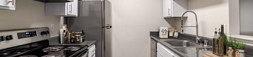 A modern kitchen with stainless steel appliances and white cabinets.