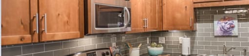 a kitchen with wooden cabinets and stainless steel appliances