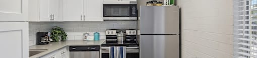 a kitchen with stainless steel appliances and white cabinets