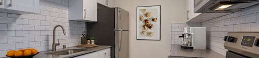 a kitchen with stainless steel appliances and white cabinets at Delphine on Diamond, California, 94131