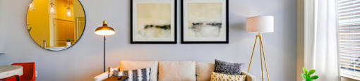 a living room with a couch and three pictures on the wall at South Side Flats, Dallas