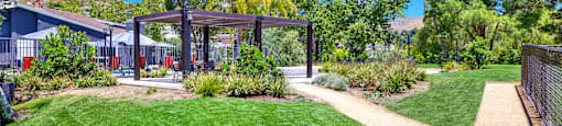 a path leading to a yard with a pergola at Monterra Ridge Apartments, Canyon Country ,91351