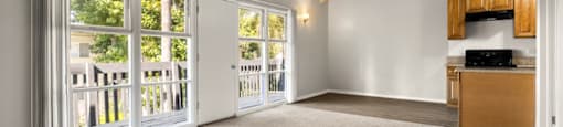 A spacious room with a wooden ceiling and carpeted floor.