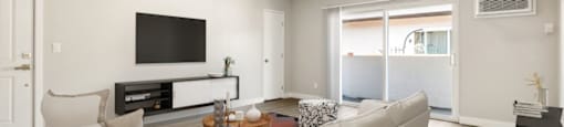 A modern living room with a white sofa and a television.